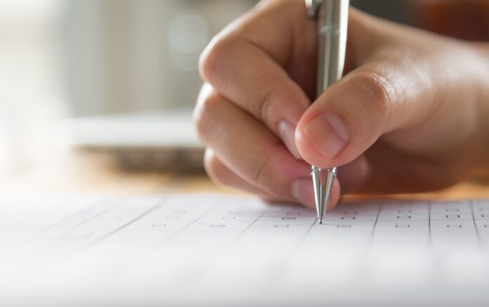 hand-writing-on-a-paper-with-a-pen-scaled